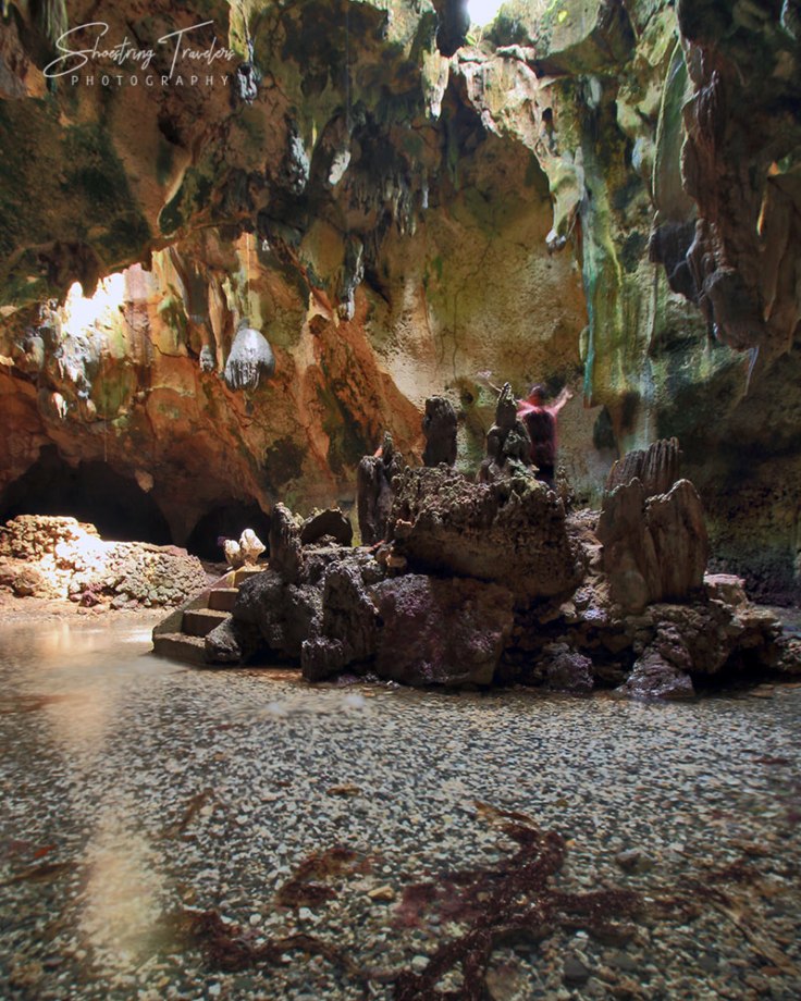 Bukilat Cave interior illuminated by sunlight from opening in the ground